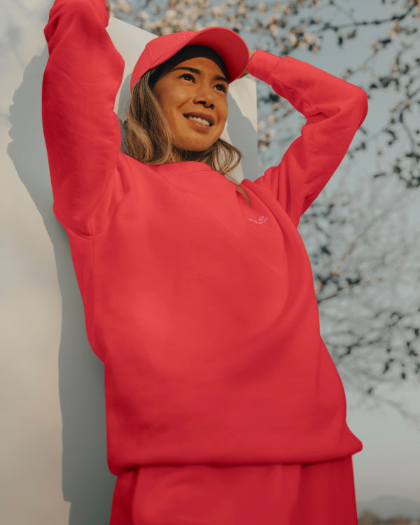 Woman in cap holding a board behind her back