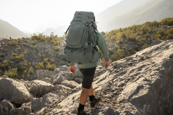Rear view of a hiker carrying a trekking backpack