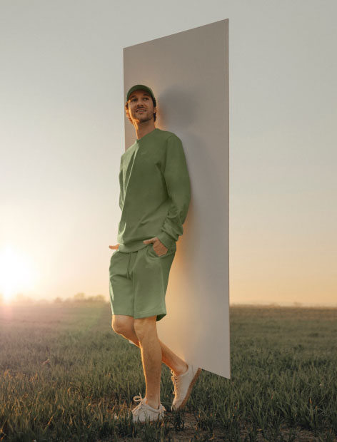 Man standing casually in front of a backdrop panel